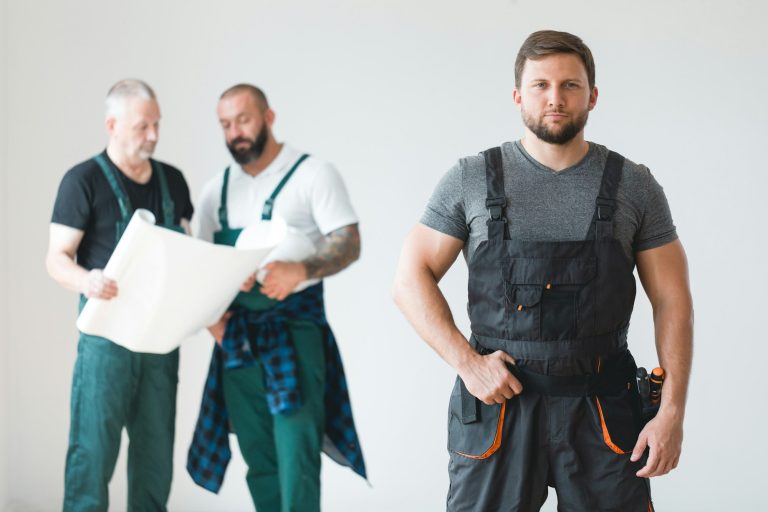 Group of three builders preparing for remodeling of the apartment